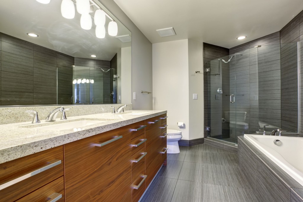 Drain Cleaning in a Bathroom Featuring a Spacious Tub and Shower