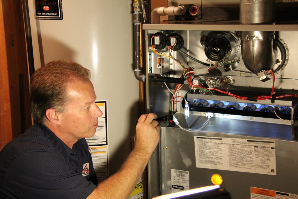 A Man Performing a Heating System Repair in a Colorado Springs Home